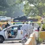 Pakistani security officials inspect the blast site after a suicide attack outside Islamabad District Courts.