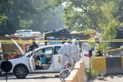 Pakistani security officials inspect the blast site after a suicide attack outside Islamabad District Courts.
