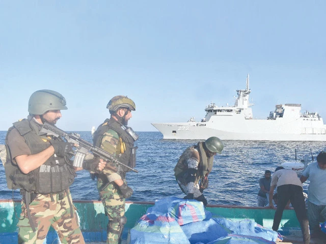 Pakistan Navy sailors search a suspicious drug-laden dhow in the Arabian Sea. Photo: INP